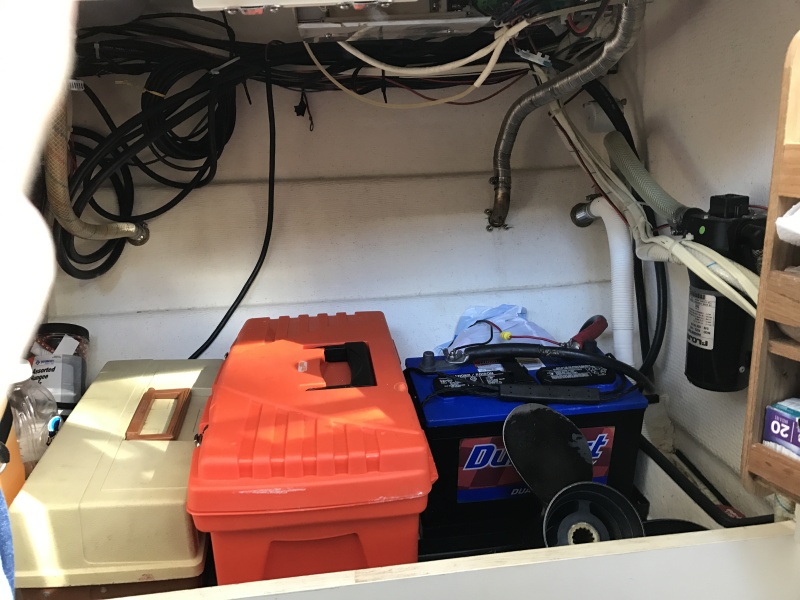Storage cabinet under galley counter. room for two 12 volt batteries for inverter.