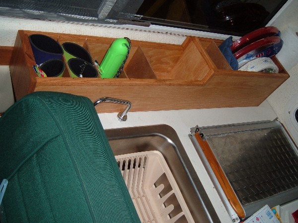 Storage compartment behind stove