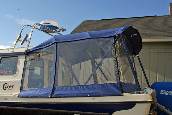 Sunbrella canvas, port side.  I wanted it to cover the spash well so I could bar-b-que in the rain.  Good thing too as it rained every weekend I was out last summer.