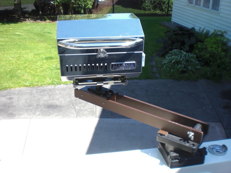 Swings out ready to BBQ.  Any grease or drips are well over the side, not on the boat.
