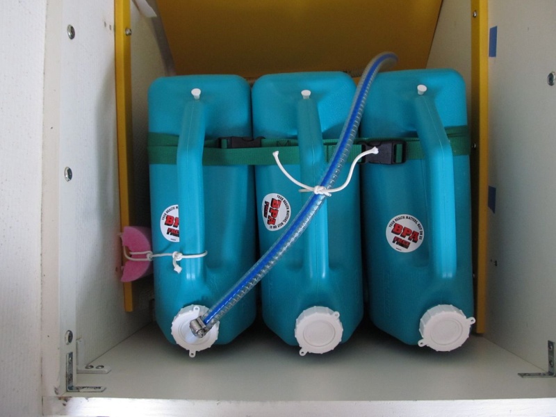 Temporary/modular water tank setup, overview.  Three 6-gallon Reliance brand water jugs - can be found at Wal-Mart, camping shops, etc.