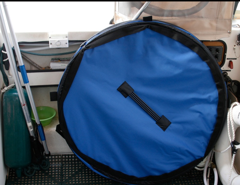 The 36 in. collapsible tub is stowed either against the starboard cockpit gunnel behind a chair or stood up in the motor well. The spring frame tub collapses to a thickness of only 2 inches and sets up quickly using the 4 fiberglass side support rods stowed on the bottom as shown.