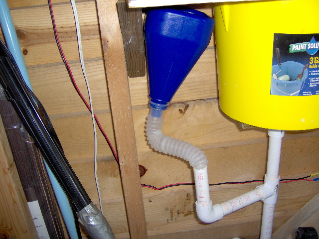 The blue funnel is on a flexable tube. I wonder if I should drill another hole in the side of our boat. It empties between the pontoons. I don't even have one in our home.