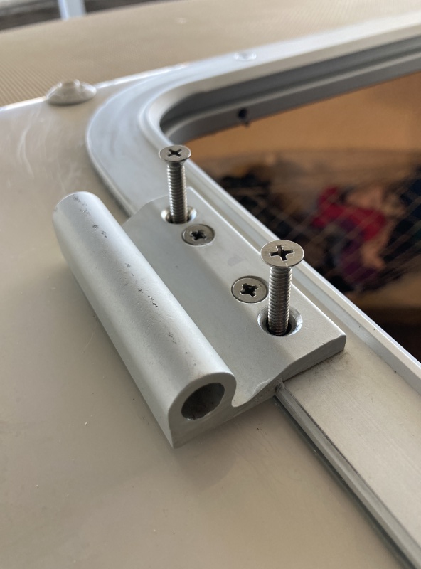 The hatch was previously fastened with wood screws (they only threaded the top layer of solid fiberglass and dug into the balsa core. I replaced them all with machine screws washers and nyloc nuts.