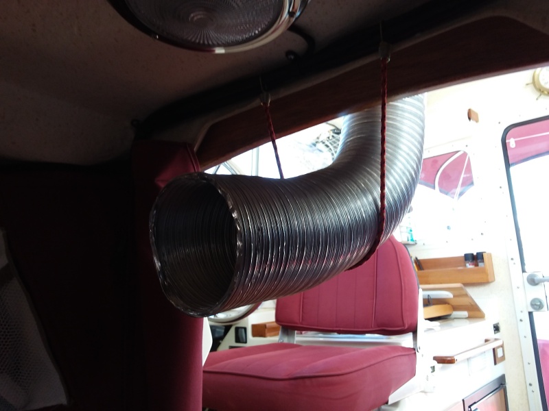 The hose simply extends into the forward cabin by a few inches and is held in place by a bungee cord.   This allows quick assembly/disassembly and also facilitates some directional placement if so desired.  I was amazed by the strength of the air flow, which quickly cooled the area