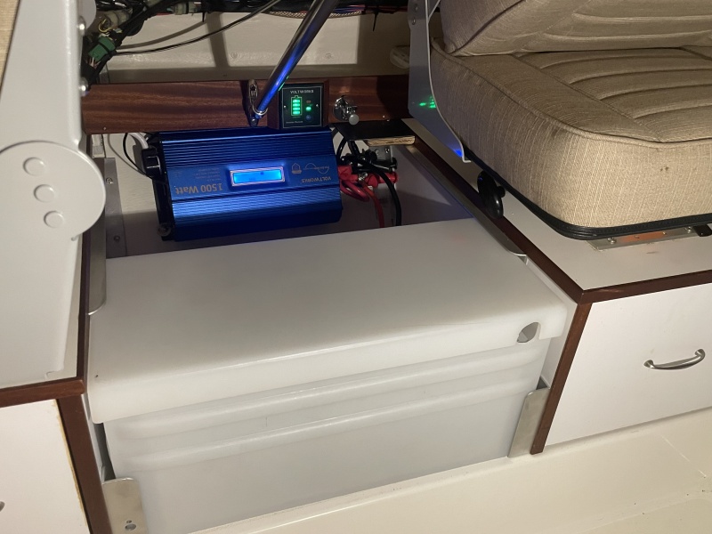 the large group D battery fit perfectly between the two storage areas.  The angle aluminum at the top edge holds it down firmly and the movable angle brackets allow the lateral movement