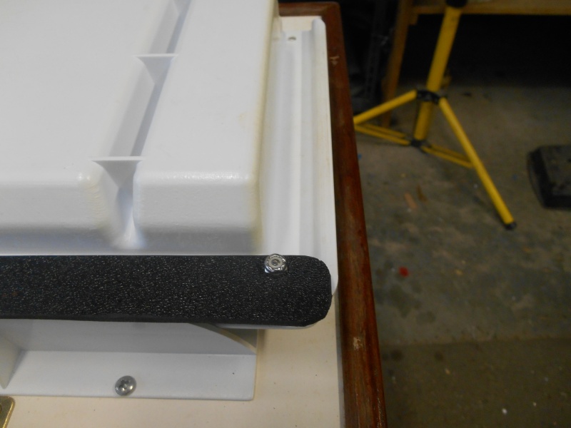 The latch is made from a piece of stiff plastic and three tiny bolts. Actually, glue would have taken the place of two bolts, but I had the bolts.  Pic is of the assembly up-side-down on the bench.  It is in the locked position.