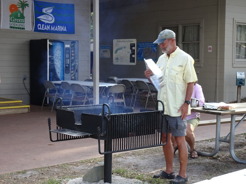 The new grill, donated last year by C Brats, is pondered by Bill.