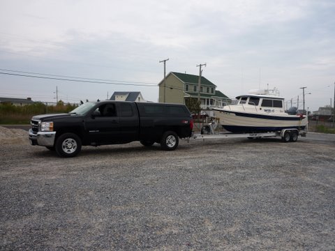 The new tow rig, 2009 2500 Chevy extended cab long bed with a Duramax Diesel and an Allison transmission weight 8100 pounds 17 to 11 mpg pulling boat mileage dependent on towing speed and tail or head wind.Boat and trailer 1/2 fuel 1/4 tank of water weighs 5540. Loaded for cruising 6000 pounds +