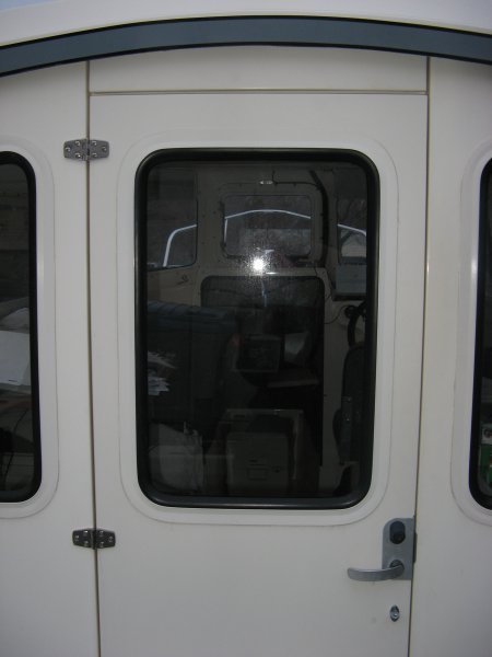 The pilothouse door of a CD-22 as seen from outside on the back deck.