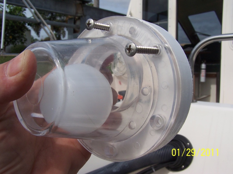 The scupper has a rectangle hole in it that goes down and the gasket that goes between the scupper and the spacer has a hole in it that the ball seats in and that hole goes up.