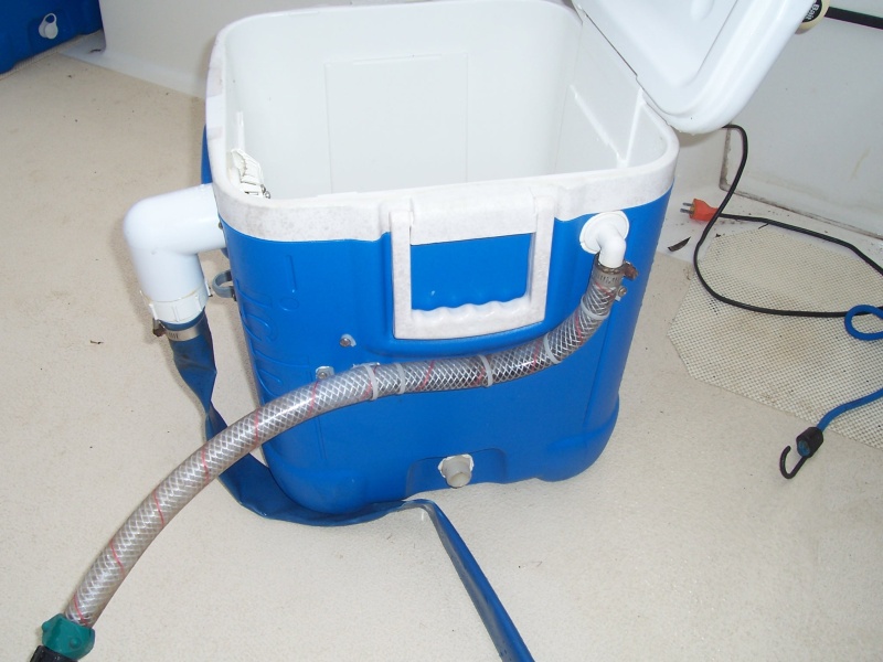 The supply hose. The flat blue hose is the drain. It slips into the cockpit drain in the back corner. The supply hose is filled from the raw water wash down, via a hose "Y".