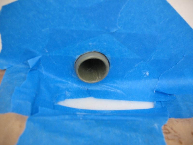 The tube bonded in on the splashwell side.  I inserted it from astern just to where I wanted it, and let it "run wild" on the outside, to be cut off later.  This made it easier to work with than a just-right-sized tube.