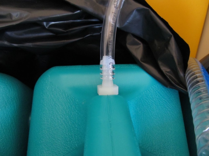The water jugs had the little white vent fittings that you push into or pull up from the hole.  I removed those and used a 3/8" drill bit to enlarge the holes, then put a couple of wraps of Teflon tape around the nylon fitting and screwed it into the jug.  Turning tank upside down there was no leakage (there was very slight drippage without the tape).  Of course these won't have that much pressure on them when right-side up.  Then pushed hose onto barb.