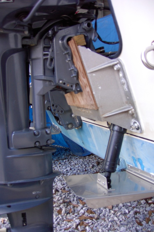 The wood 1x1 that elevates the engine gives a bit of clearance at the tab. The real purpose is because the two screw clamps that hold the kicker will hit the stern of the boat.