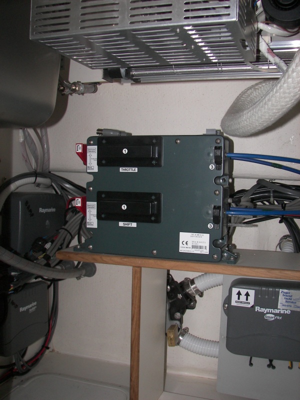 These are the electric/hydraulic controllers for the Teleflex/Morse fore and aft control stations. They cover the "Y" valve for the head tank macerator discharge. The Wallas stove can be seen at top.