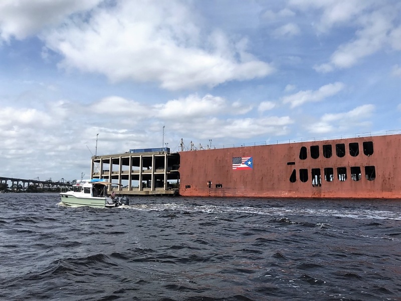 This cargo ship was being loaded with semi trailers.
