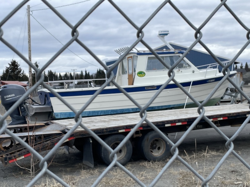 This is a 26? Fisherman I think they?re called, probably late 80s or 90s boat. Parked in the Alaska DOT lot in Ninilchik April 2024. I?ve seen others like this but not this boat, unless it maybe used to be in Seward. Has a AK charter fishing reg sticker. Possibly converted from an I/O given the metal bracket. Looked clean.