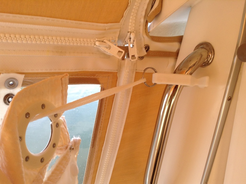 This is a close-up of the clip attached to the hand.  Notice that the curtain can easily be drawn with the rope and clip in place.