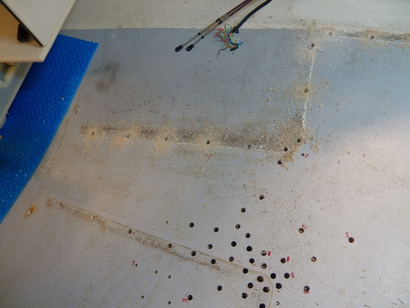 This is a good picture of the most extensive damage.  The dark holes on the port side indicate rotten wood where the seat box pop rivets leaked the most.  I have left the swarf from the drilled out rivet holes on the starboard helm seat.  You can see by the color of the swarf that the wood is good and gets better towards the bow.  The V berth support posts were also removed (both good, but need reinforcement because of my new permanent gas tank).