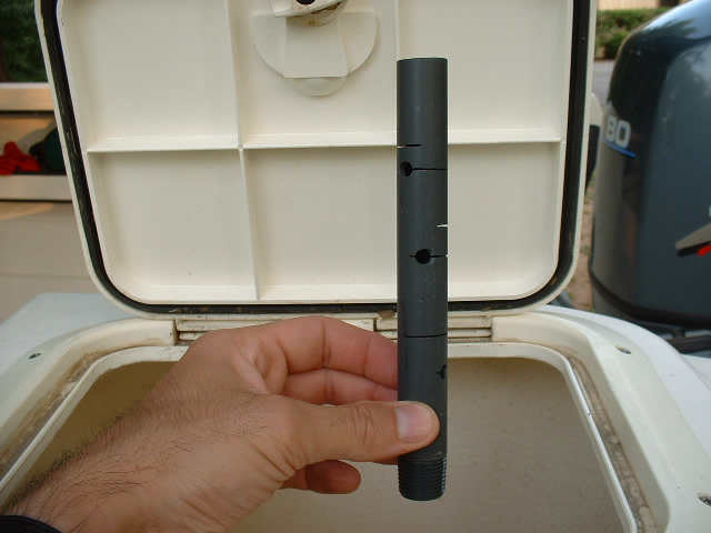 This plastic tube screws into a fitting on the bottom of the tank. The tube is drilled to allow water to drain slowly and prevents small bait from being sucked down the drain.