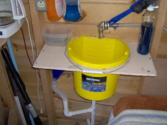 This sink setup is in the DogHouse boat on the back page. Guess what the little blue funnel is for. See next photo.