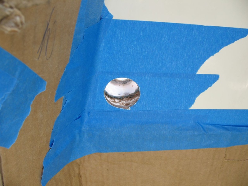 Transom side of empty hole.  What you are seeing is the balsa core of the transom, followed by the forward fiberglass skin of the transom, and then the (white) filler that fills the gap between the splashwell molding and the forward transom skin.