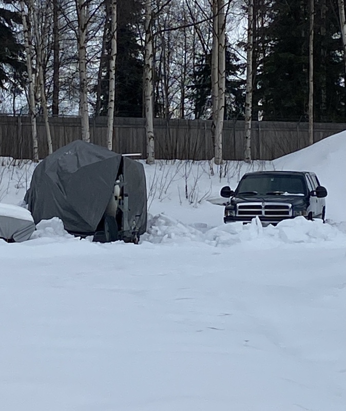 Truck and boat await spring.