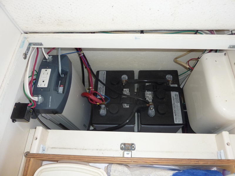 Two 6 volt sealed batteries and a 3000 watt inverter under the dinette seat.  Will power the microwave, coffee pot and electric skillet. Recharges batteries when running the generator or with shore power.