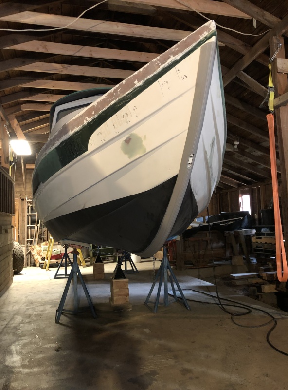 Two layers of Pettit Vivid bottom paint were applied over the primer coats. The original brass keel guard was removed, the screw holes were drilled out and filled with thickened epoxy, then the keel guard was re-installed. The newly applied bottom paint was sanded away where a new 8' KeelGuard would go, and it was installed over the original keel guard.