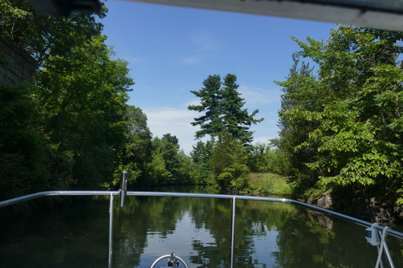 Typical Rideau entrance canal into a lock with solid granite to starboard.