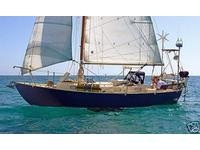 Under sail. New owner added all the stuff on the transom.  I had a nice seat and a wind vane there.