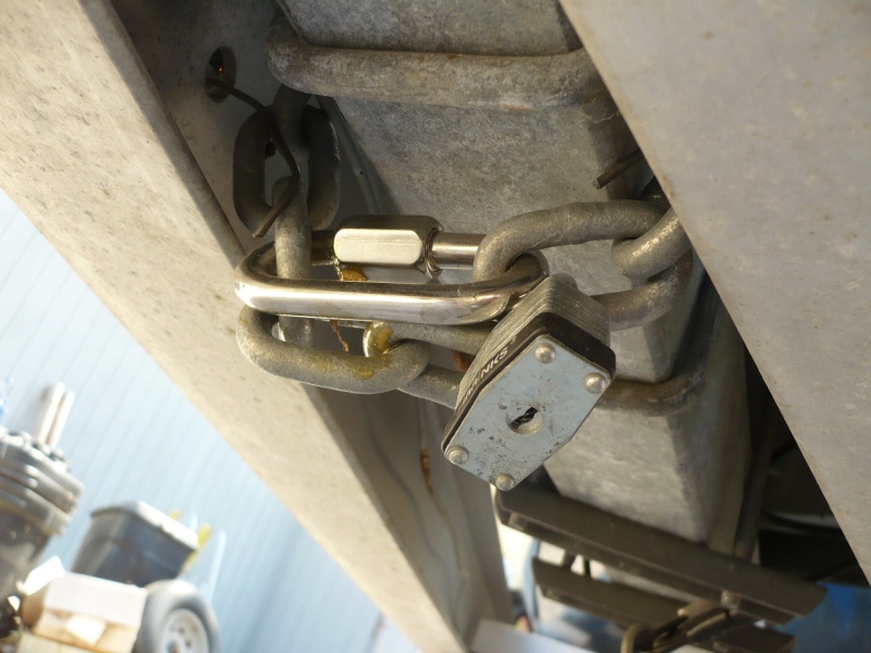 Underside how chain is attached to main trailer beam. Stainless screw on with dab of JB weld and padlock for security.