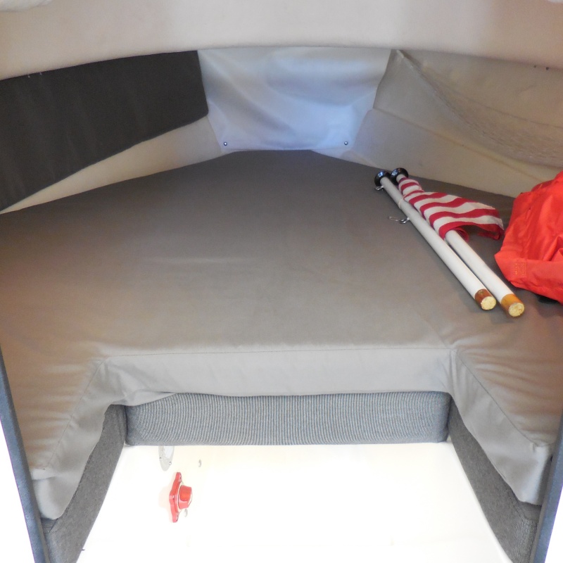 V Berth, 4" Memory Foam Topper, covered in Sunbrella. Port Bulkhead insulator Cushion. Storage Hammock on Starboard bulkhead