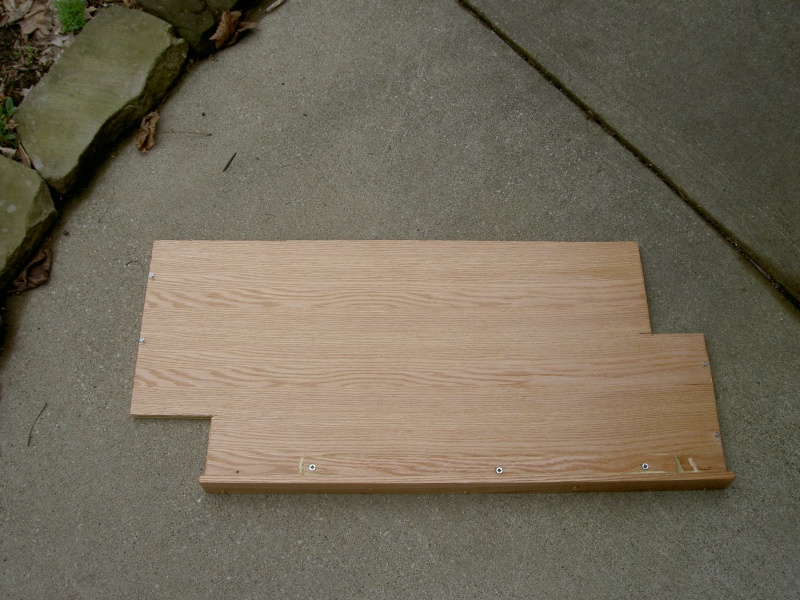 (Valkyrie) Step one: basic shelf with cut-outs for Wallas tank and through-hull hoses.  Shelf is secured to oak blocks attached to bulkheads with screws and West System epoxy.  Fiddle is 3" tall,1/4 inch thick.  Fiddle is also reinforced for sturdiness by a 1"x 1" piece of oak that is attached by glue and screws.