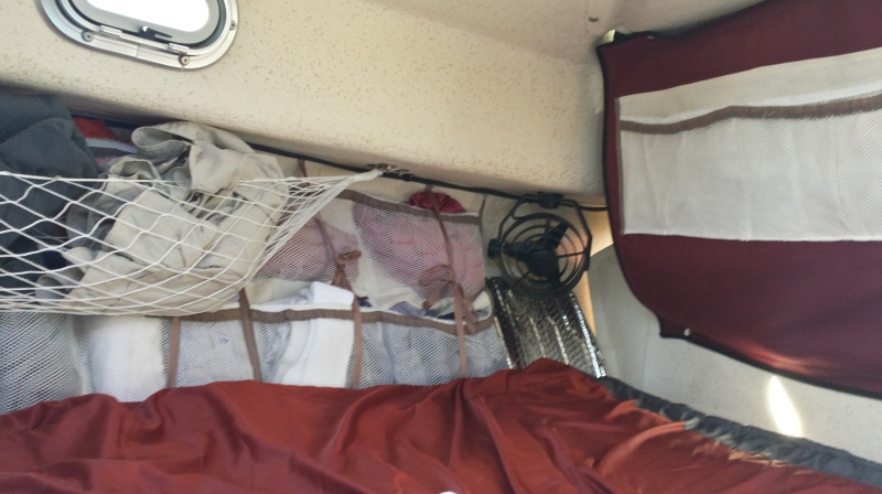 vberth with hammock over clothes organizers over reflective window panels