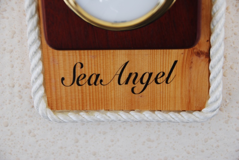 Vessel name was printed with MS WORD on a 'Clear Shipping Label', 11/2"x41/8", by AVERY. It was set in place and sprayed with a clear acrylic spray that you can get at any art supply or hardware store. The 3/8" line was hot glued to the base's outer edge.