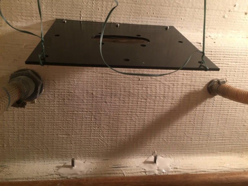 View of bracket bolts beneath mounting plate