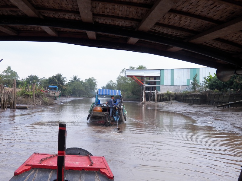 We followed this boat through a narrow canal at low tide, staying back far enough not to get sprayed when he had to lift his prop.  His discharge water would vary in color from light chocolate to dark chocolate depending on the amount of mud in the cooling water.