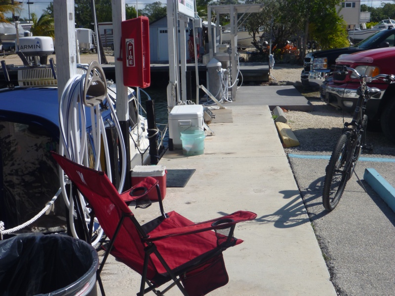 We turned our slip area at the dock to our home for the month. Note grill extra fish cooler to swap out with food cooler on the boat when fishing. Bucket for washing boat coolers and truck Out standing fish cleaning table nearby. Also note our black truck close by for access to extra stuff we don't need on the boat all the time.