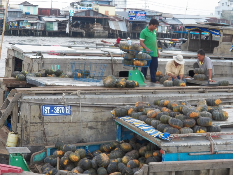 We visited the floating market in Can Tho.  This is a "wholesale" market with the anchored large vessels selling to smaller vessels that will distribute the wares along the little man-made canals on the Mekong.