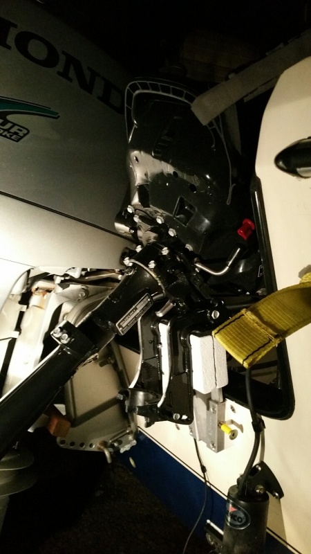With Suzuki tilted up and strapped forward to boat