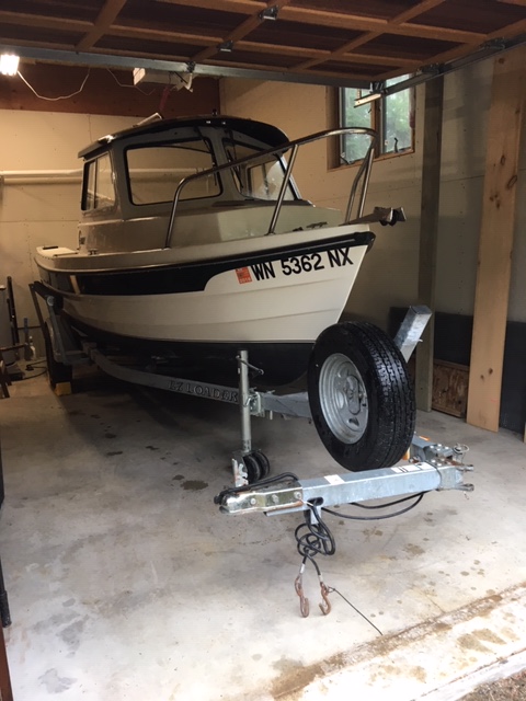 Yeah she fits! 2008 16 angler tucked in garage. Trailer tongue folded leaves 6 inches of lengthwise clearance.
