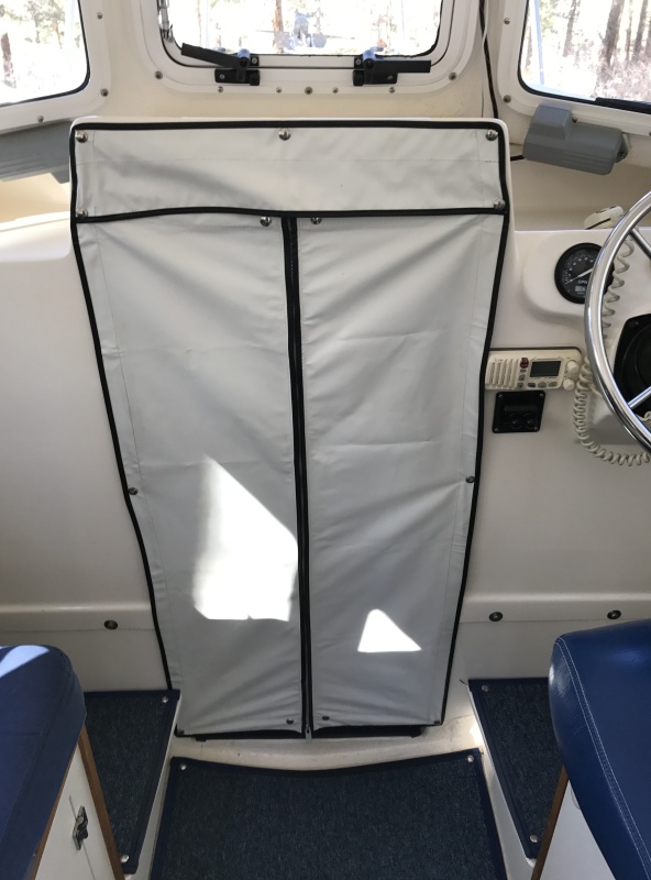 Zippered vinyl V-berth privacy curtain.